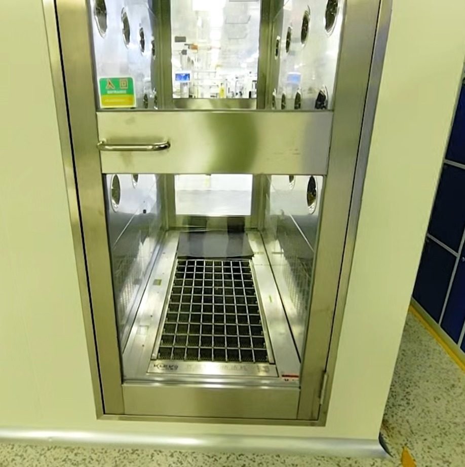 Pass-through unit set into an air shower doorway